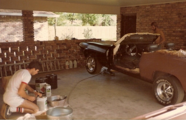 Mark Harrell mixing paint while John Keenon (in background) sprays the 69 Camaro.